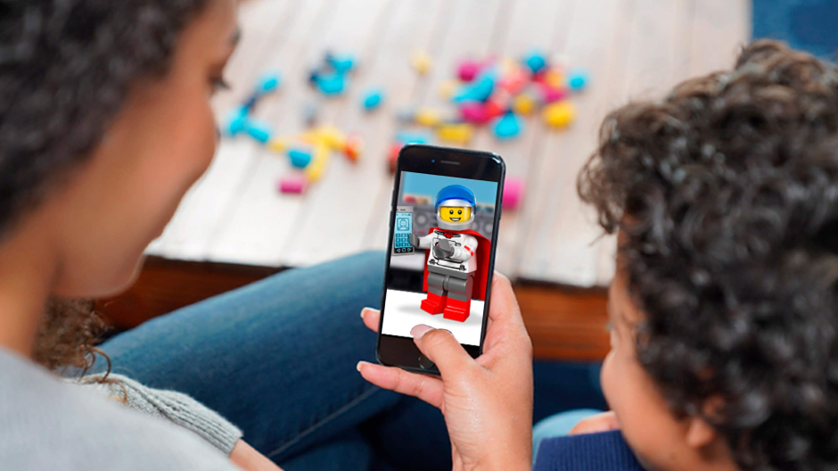 Image of a woman and a little boy both looking at phone held by the woman